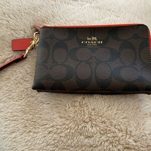 A beautiful brand new Coach double zippers wristlet. Never been used!